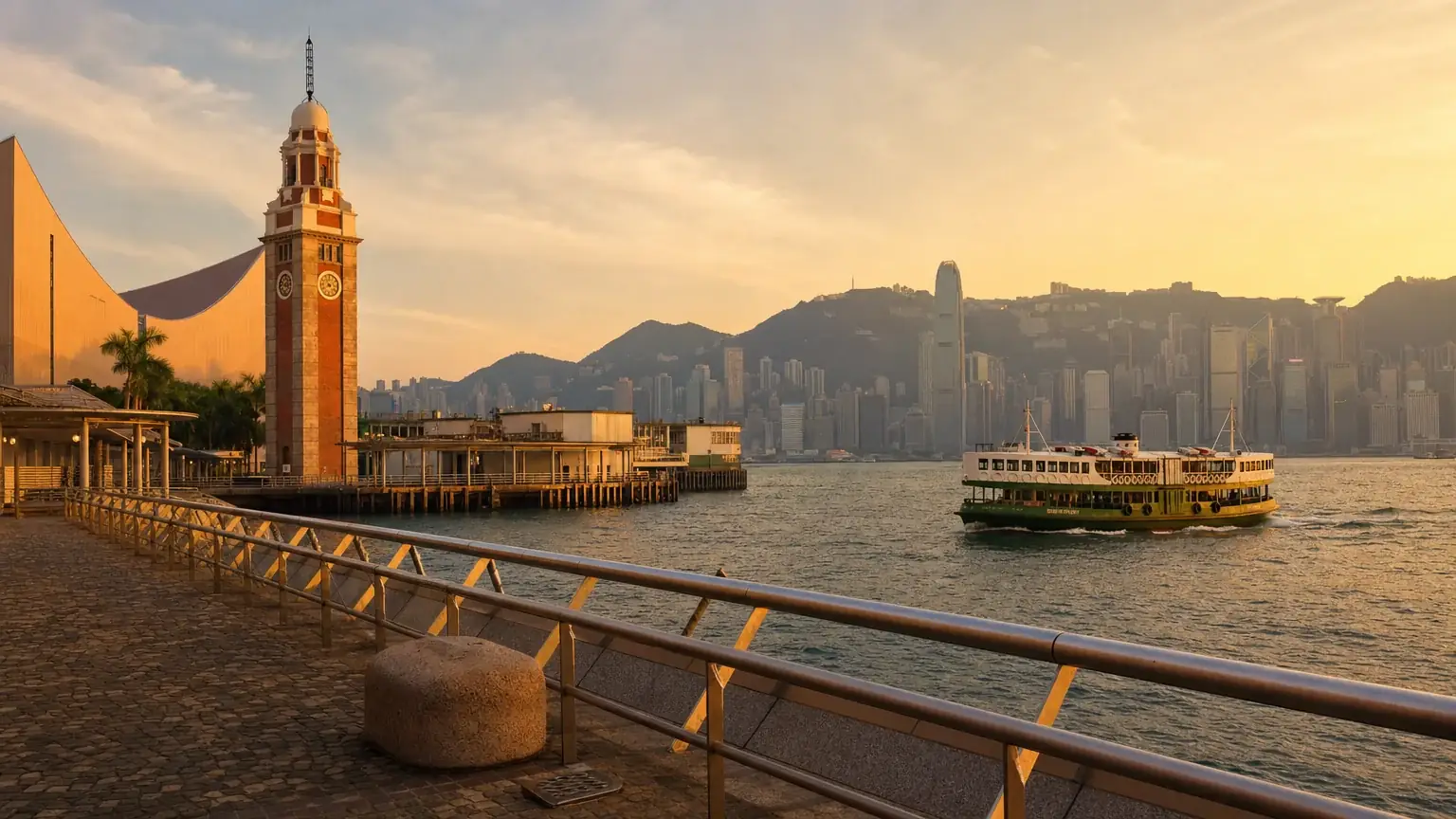 The Tsim Sha Tsui waterfront with a Star Ferry on the harbour at golden hour